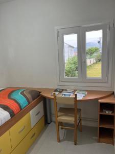 福斯Viviendas uso turístico REME II的一间卧室配有一张床和一张带窗户的书桌