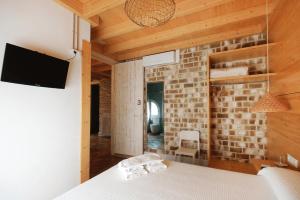 滨海圣波尔B&B Sant Pol - Adults Only的一间卧室设有一张床和砖墙
