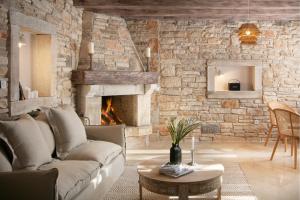 BurićiResidence Pietre d'Istria - with private service的带沙发和石墙的客厅