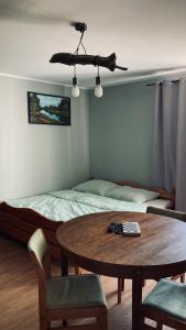 斯图托沃Czapla siwa的一间卧室配有桌子、床和桌椅