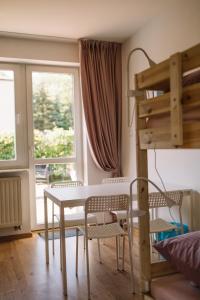 克拉科夫Girls Willa的客房设有桌椅和高架床。