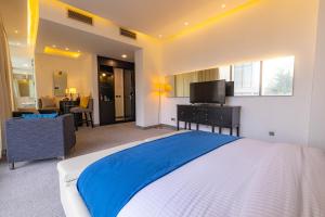 安曼Boho Boutique Hotel Amman的一间卧室配有一张带蓝色毯子的大床