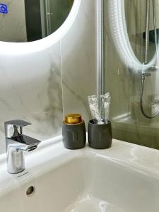 阿特劳Talan life aparts的浴室水槽设有2个蜡烛和镜子