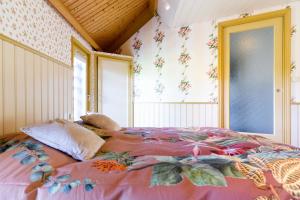 韦斯普欧佛霍恩农庄的一间卧室配有一张带粉色毯子的大床