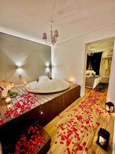 格拉玛多薰衣草旅馆的一间位于地板上,配有红色玫瑰浴缸的客房
