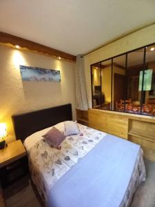 阿尔克河畔博讷瓦勒Chalet Campanule的一间卧室设有一张大床和一个窗户。