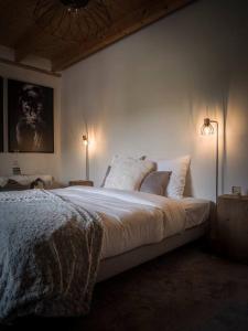 圣若里奥Venez Chez Vous - La Grange du Lac - Vue montagne的一间卧室配有一张大床和两盏灯