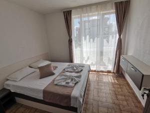 茨雷沃Arapya Apartments的一间卧室设有一张床和一个大窗户