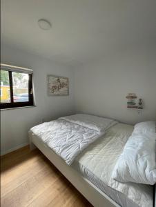 沙博伊茨Haffkrug Beach Bungalow的一间卧室设有两张床和窗户。