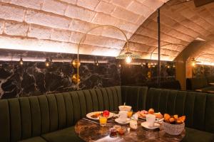 巴黎阿斯顿酒店的用餐室配有餐桌和食物