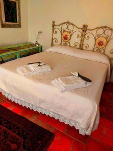 蒙泰斯库达伊奥Residence La Villa的一张带两条毛巾和一把刀的床