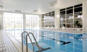 丰冈市蓝岭酒店的大楼内一个蓝色的大型游泳池