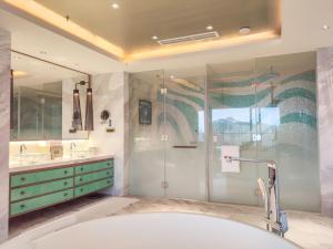 三亚三亚山海天JW万豪酒店(自然采光儿童俱乐部)的带浴缸和玻璃淋浴间的浴室。