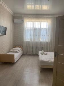 AralʼskКеруен сарайы, гостиница的一间小卧室,配有两张床和窗户