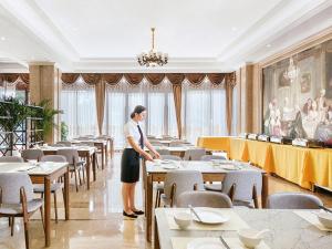 瑞安维也纳国际酒店浙江温州瑞安塘下店的女人站在饭厅里