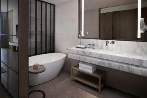 三亚三亚亚龙湾万豪度假酒店（2020年焕新升级·C位海景）的带浴缸、水槽和镜子的浴室