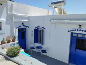 Péran TriovasálosMari...Milo的白色的房子,设有蓝色的门和庭院