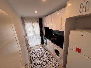 特拉布宗PURPLE VIP SUITE的一间带水槽和冰箱的小厨房