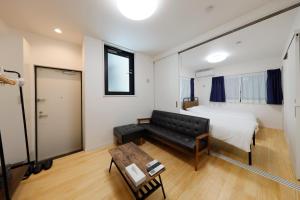 东京Setagaya House的一间带沙发、床和桌子的卧室