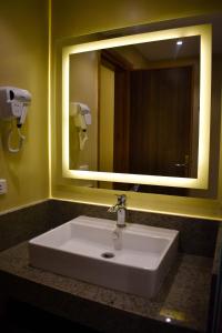 赫尔格达Al Dora Residence Suites Hurghada的浴室水槽和上面的大镜子