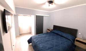 萨尔塔Nice Full Apartment Downtown Salta的一间卧室设有蓝色的床和窗户。