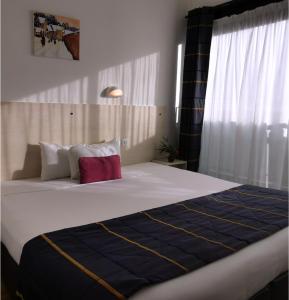 巴登戈维尼斯之家酒店的一间卧室配有一张大床,提供蓝白色的毯子