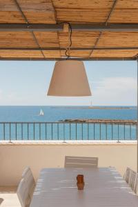 加利波利Dimora San Felice Il Fico的桌椅,享有海景