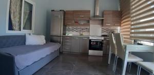 内亚卡瓦里Soula's Sunshine Apartments的一间配有沙发和桌子的厨房
