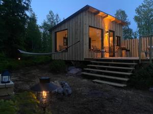 图什比Forest cabin with stunning mountain view & Sauna的夜间树林里的一个小小屋