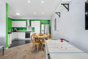 布莱顿霍夫Modern Eco House With Parking的厨房配有白色橱柜和桌椅