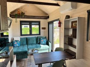 羊角村Tiny House Lovely Sunshine的客厅配有沙发和桌子