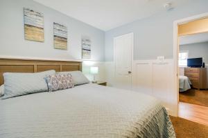 默特尔比奇Summertime Escape with Grill Walk to Atlantic Beach的卧室配有白色的床和电视。