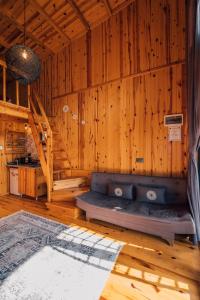 萨潘贾SAPANCA KURUÇEŞME TINY HOUSE的一间木制客房内的沙发