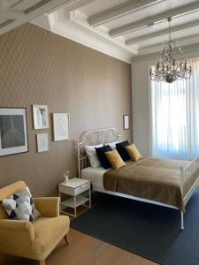哈莱姆Appartement Downtown的一间卧室配有一张床、一把椅子和一个吊灯。