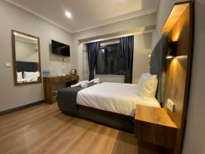 伊斯坦布尔Zeyn Otel Istanbul的酒店客房,配有床和镜子