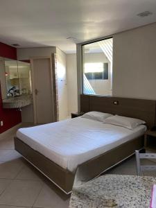 圣若泽Motel Kalipso的一间卧室设有一张大床和大窗户