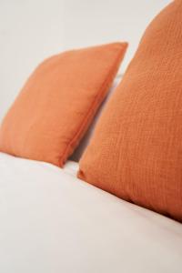 格拉斯哥Rotherwood Apartment的床上的2个橙色枕头