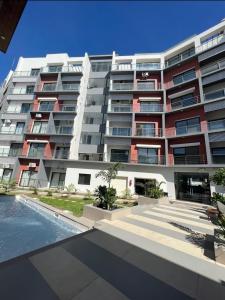BijiloAquaview Amina's rental apartment的一座大型公寓楼,前面设有一个游泳池