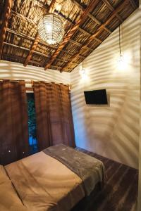 阿卡普尔科Kali Village的一间卧室配有一张床和一台平面电视