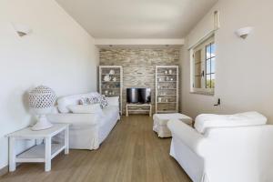 马鲁焦L'Attico di Alessia by BarbarHouse的客厅配有白色家具和砖墙