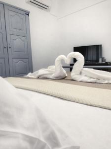 卡利塞亚-豪客迪克斯Diamond's House的卧室里床边的两只天鹅