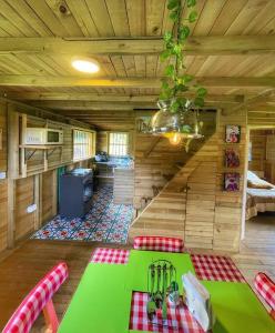 El PeñolEspectacular Cabaña Loft en Guatape - Jacuzzi的小屋内带绿桌的房间