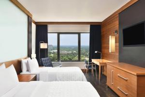 新德里新德里艾美酒店 的酒店客房设有两张床和一台平面电视。