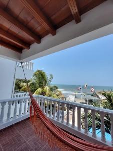 卡塔赫纳hotel 3 banderas Manzanillo del Mar的俯瞰海滩的阳台的吊床