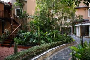 加德满都Hotel Thrive, A Tropical Courtyard的一座带楼梯的建筑前的花园