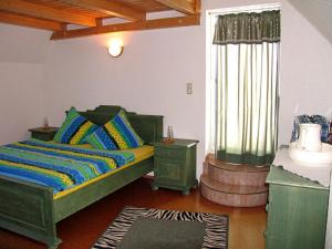 GeisaFerienwohnung Seeleshof的一间卧室设有一张绿色的床和一个窗户。