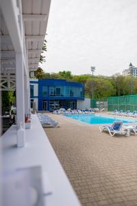 敖德萨奥特拉达黑海酒店的一座带躺椅的游泳池和一座建筑