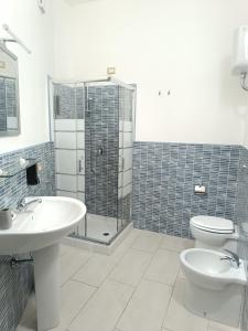 GibaLa Residenza B&B的一间带两个盥洗盆、淋浴和卫生间的浴室