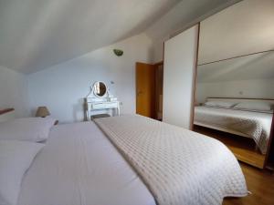 波尔Dalmatian Villa Denis的一间白色卧室,配有两张床和镜子