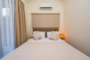 厄吕代尼兹糖果海滩俱乐部酒店的一间卧室配有带白色床单和枕头的床。